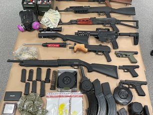 Several search warrants executed resulting in many weapons, drugs & money being seized.