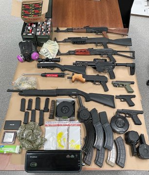 Several search warrants executed resulting in many weapons, drugs & money being seized.